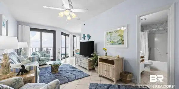 Image 4: Living area with a textured ceiling, a ceiling fan, and light tile patterned floors