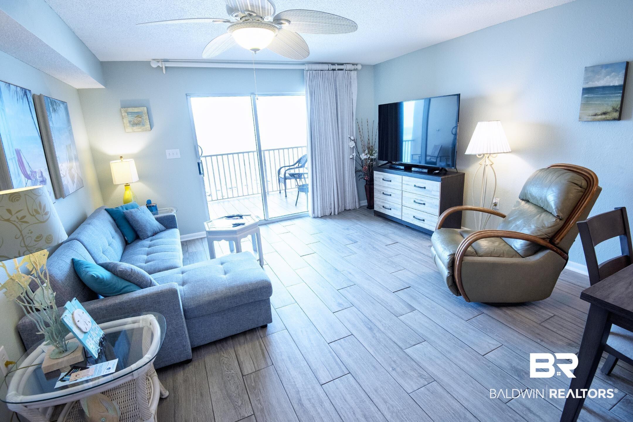 Image 2: Living room featuring ceiling fan, a textured ceiling, and light hardwood / wood-style floors