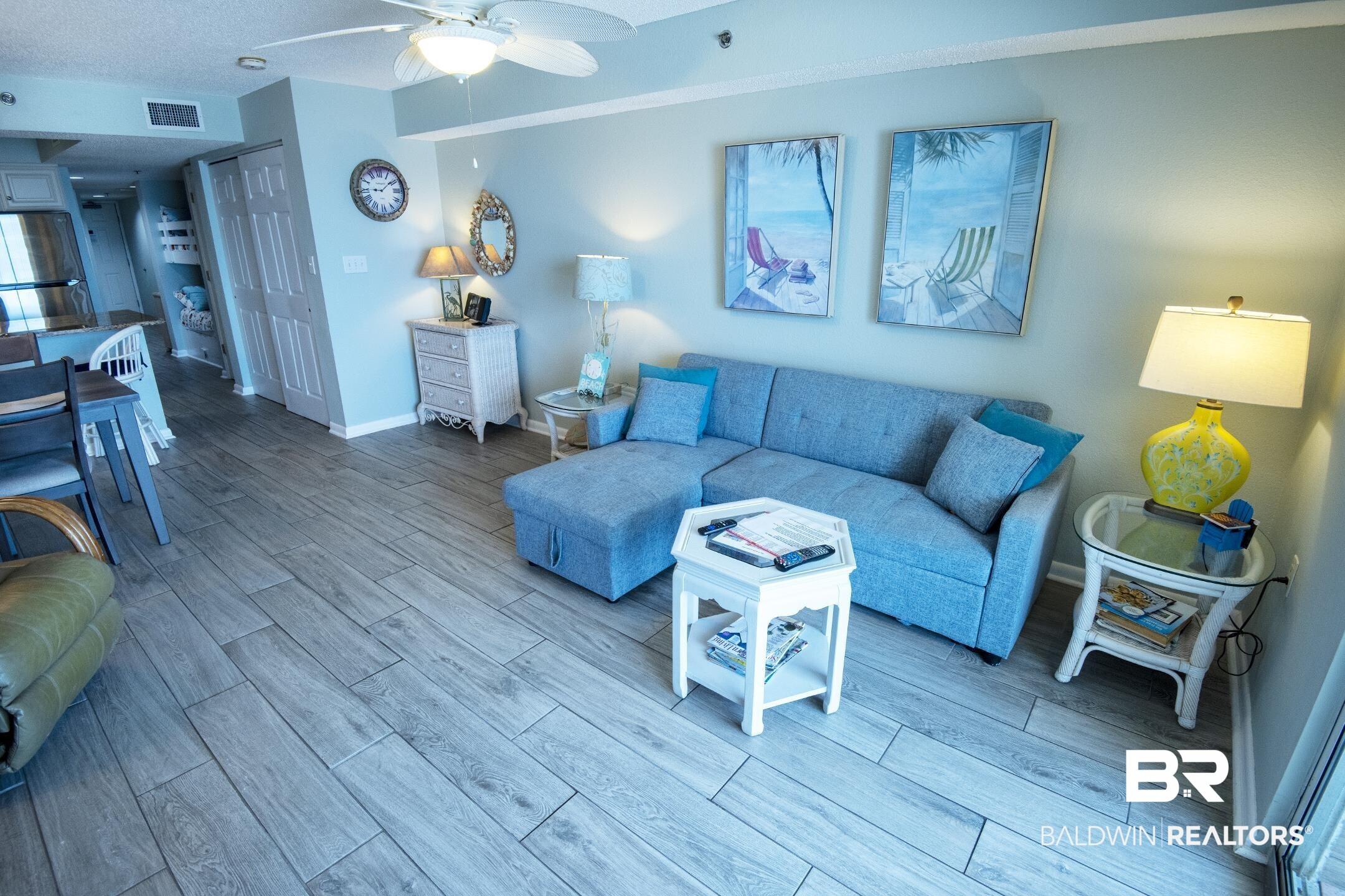 Image 3: Living room featuring light hardwood / wood-style floors and ceiling fan
