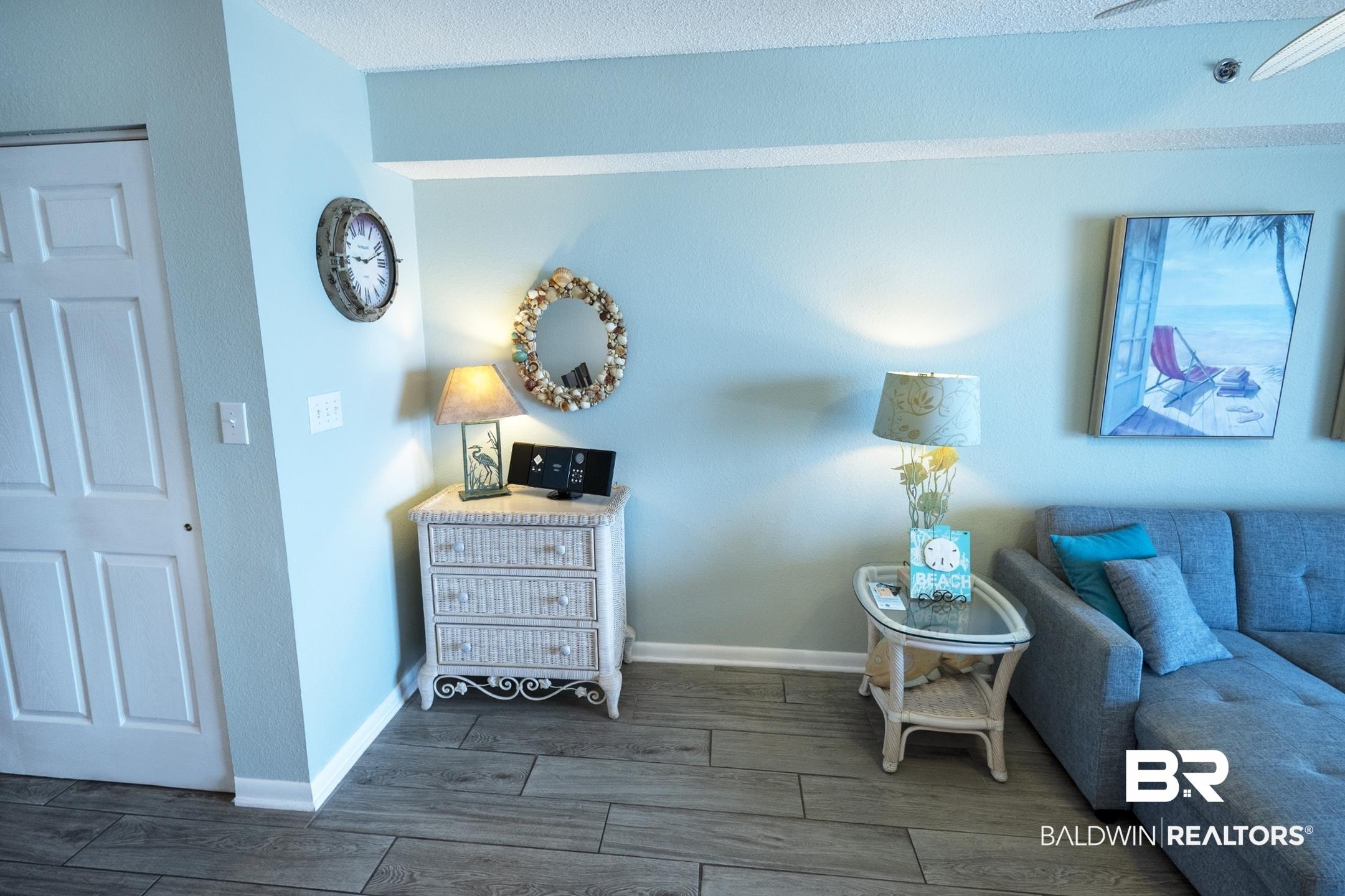 Image 4: Living room with dark wood-type flooring and a textured ceiling