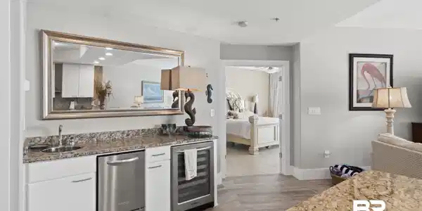 Image 4: Wet bar featuring a stainless steel undercounter refrigerator, stainless steel ice maker, granite countertop, and wood-finish flooring