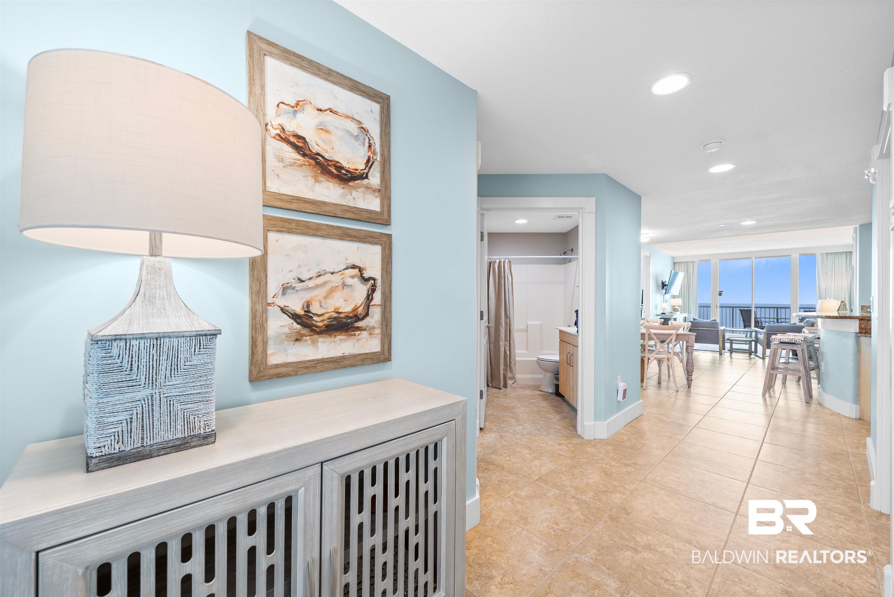 Image 2: Corridor with recessed lighting and light tile patterned floors