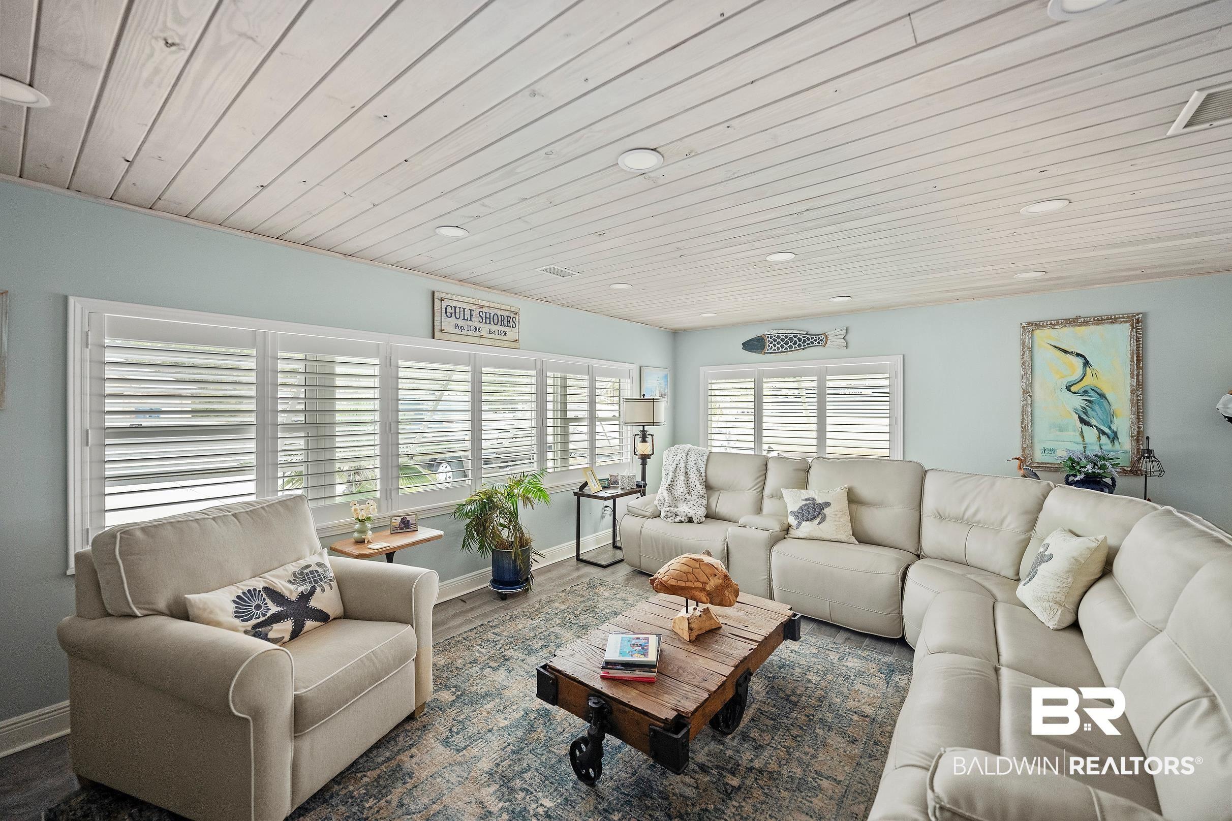 Image 3: Living room with wooden ceiling, wood finished floors, and recessed lighting