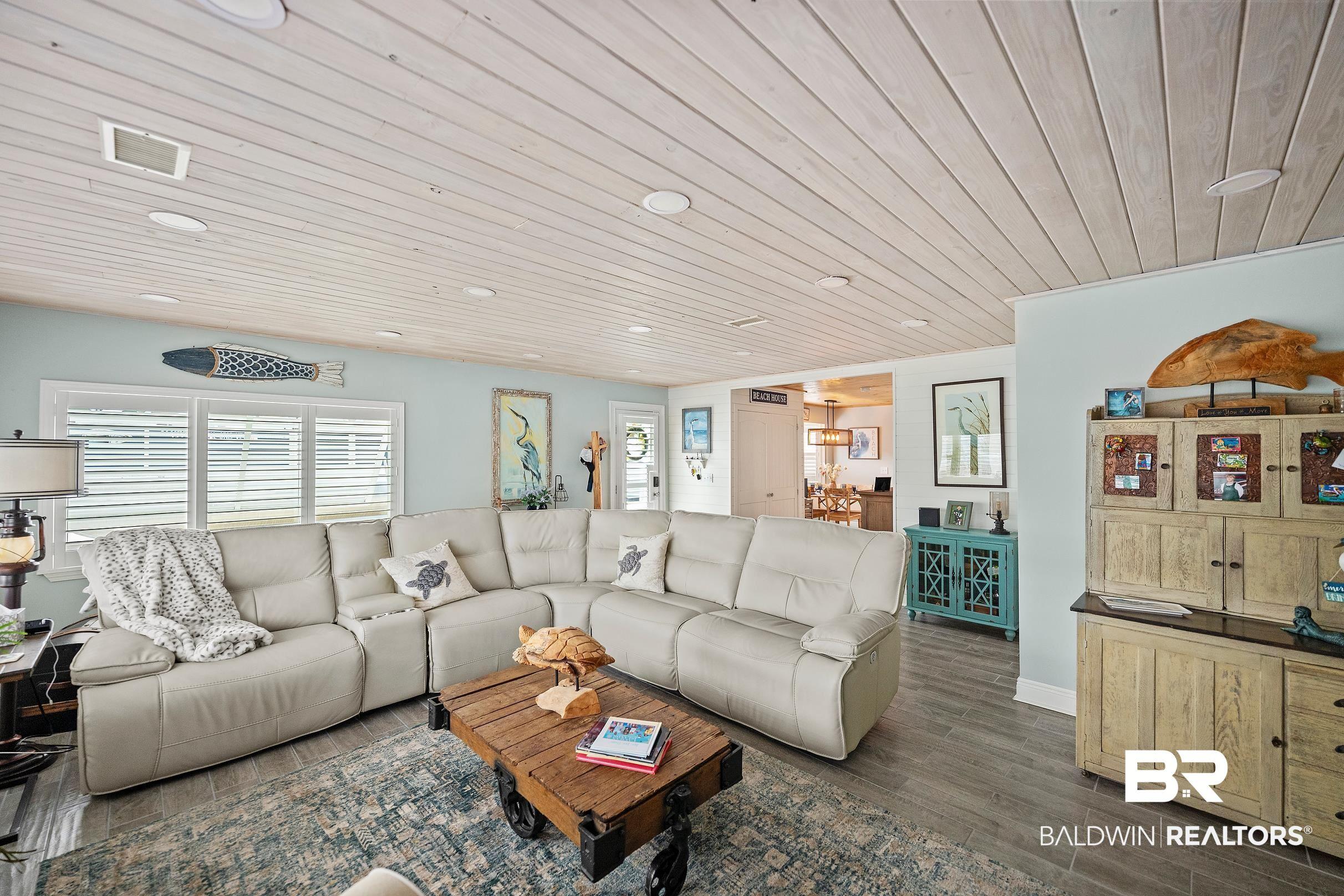 Image 4: Living area featuring wood ceiling and dark wood-style floors