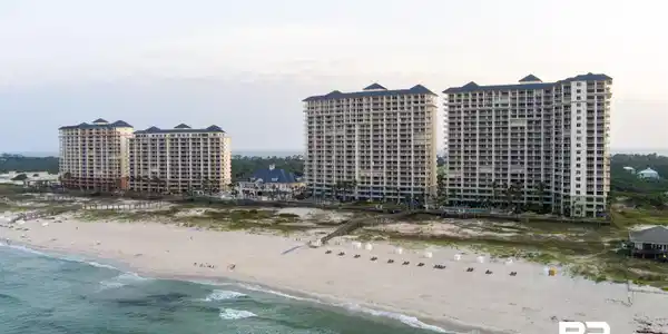 Image 2: Beachfront condominium complex featuring multiple high-rise buildings situated directly on a sandy shore