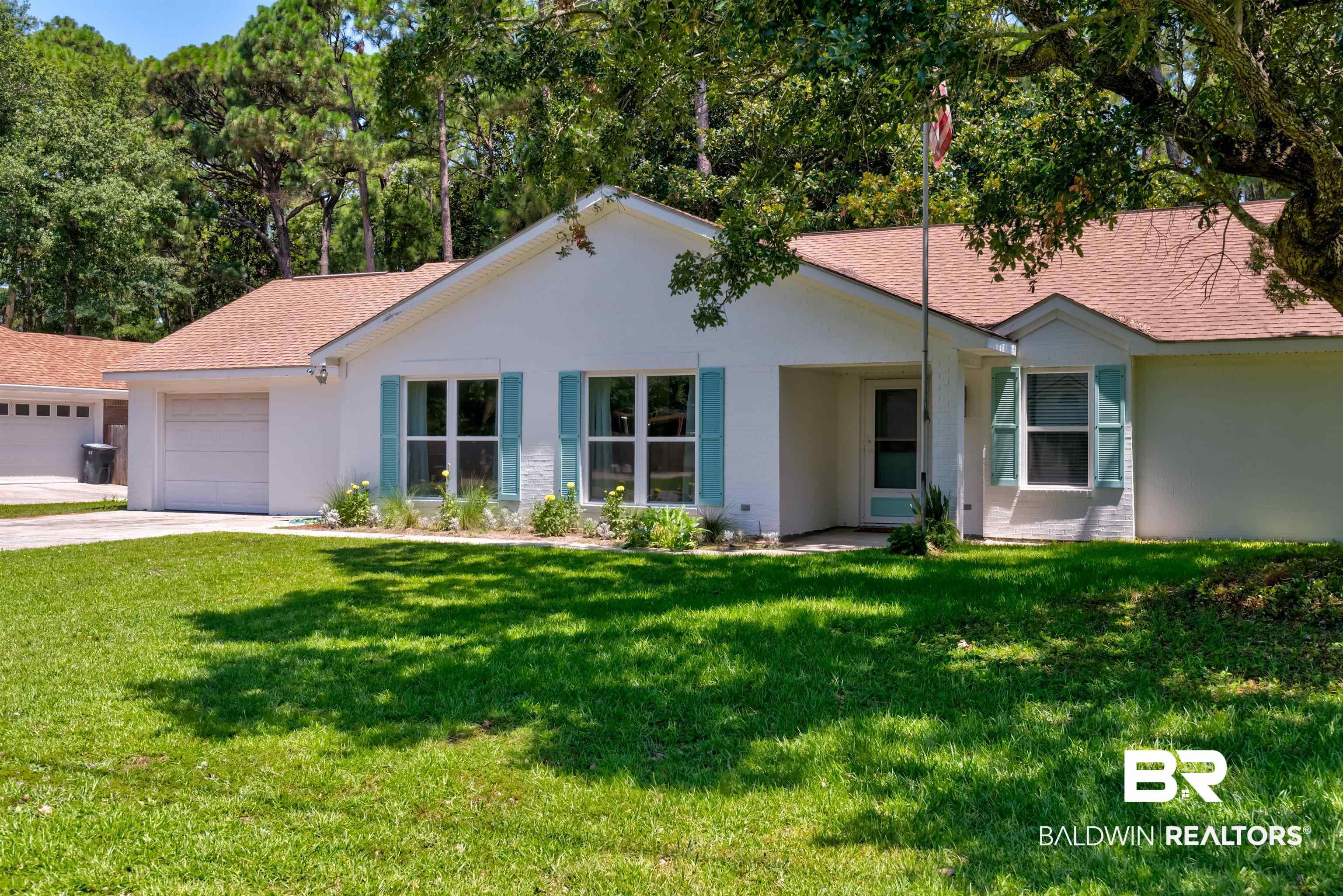 Image 1: Ranch-style home featuring a front yard, roof with shingles, an attached garage, and stucco siding