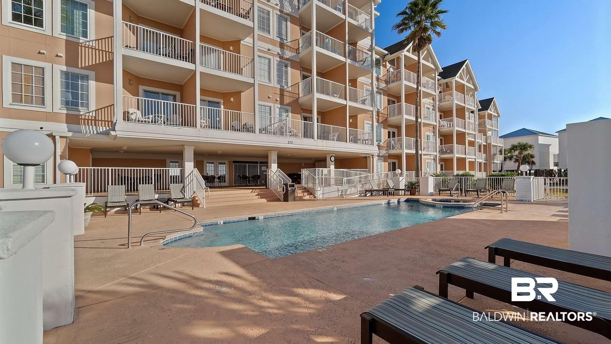 Image 4: Community pool with a patio area