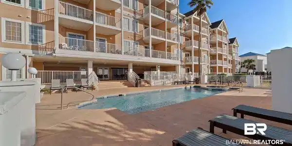 Image 4: Community pool with a patio area