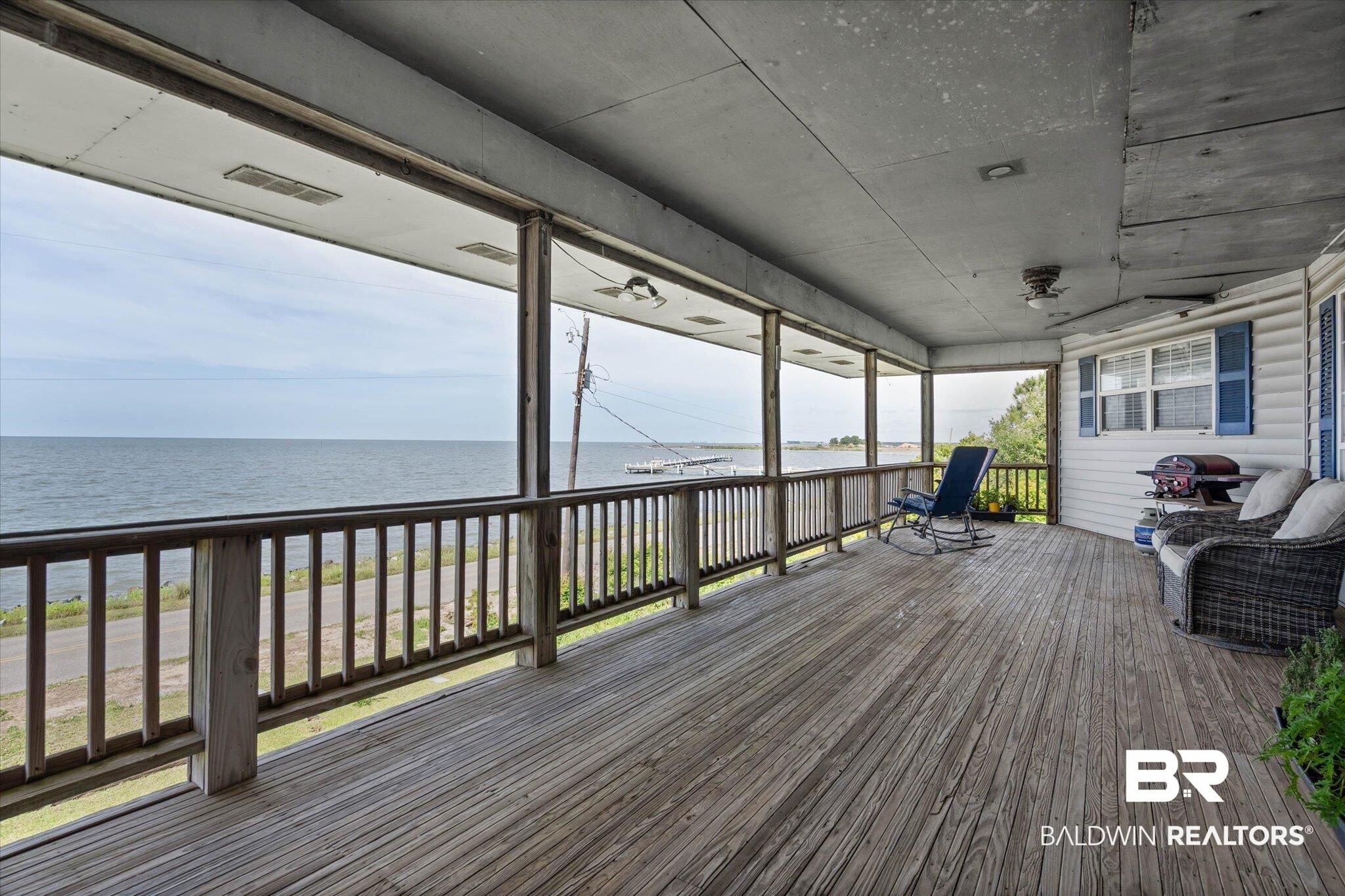 Image 4: Expansive wood deck with a wide-open water view