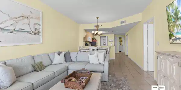 Image 4: Open concept living area with light-toned walls and tile flooring