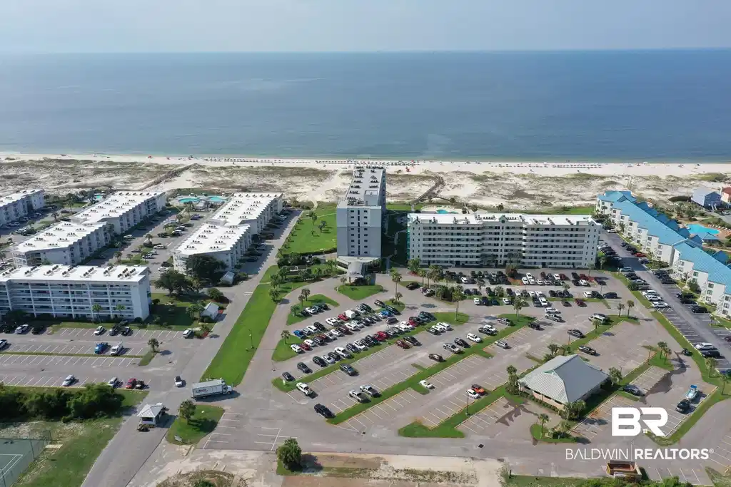 Image 1: Bird's eye view of apartment complex and expansive beach