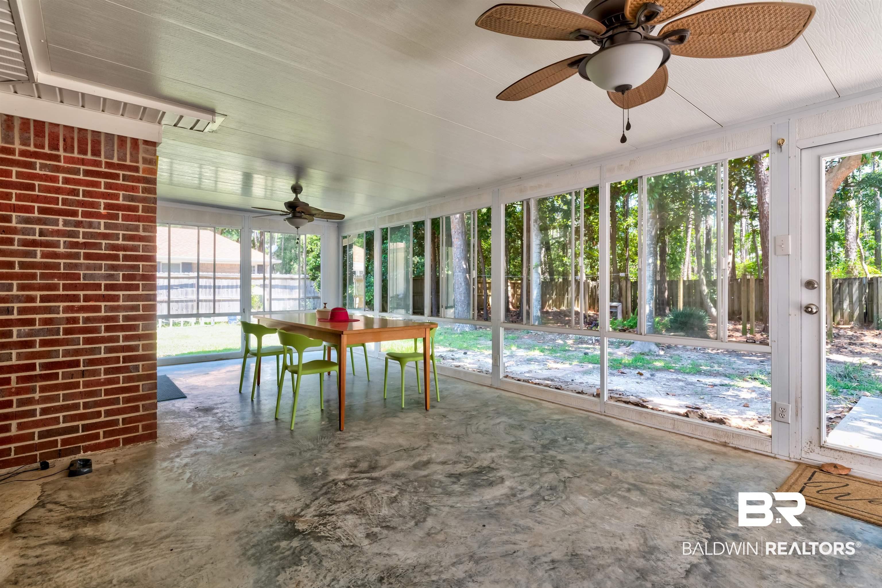 Image 4: Unfurnished sunroom featuring a ceiling fan and outdoor dining area
