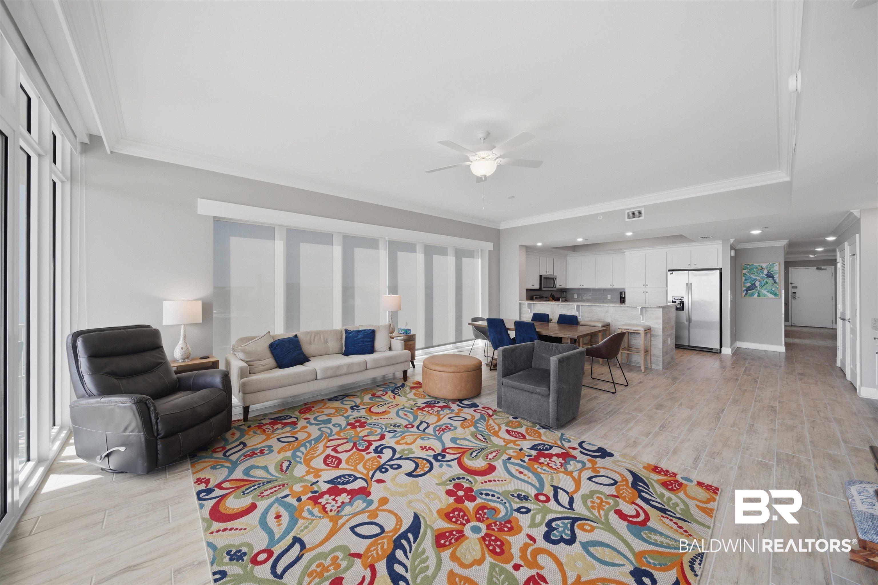 Image 4: Living area featuring ornamental molding, a ceiling fan, and wood finish floors