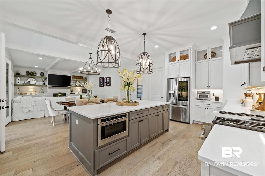 Image 3: Sample of Builders work. Not actual home.              Open Kitchen with large island and Quartz Counters