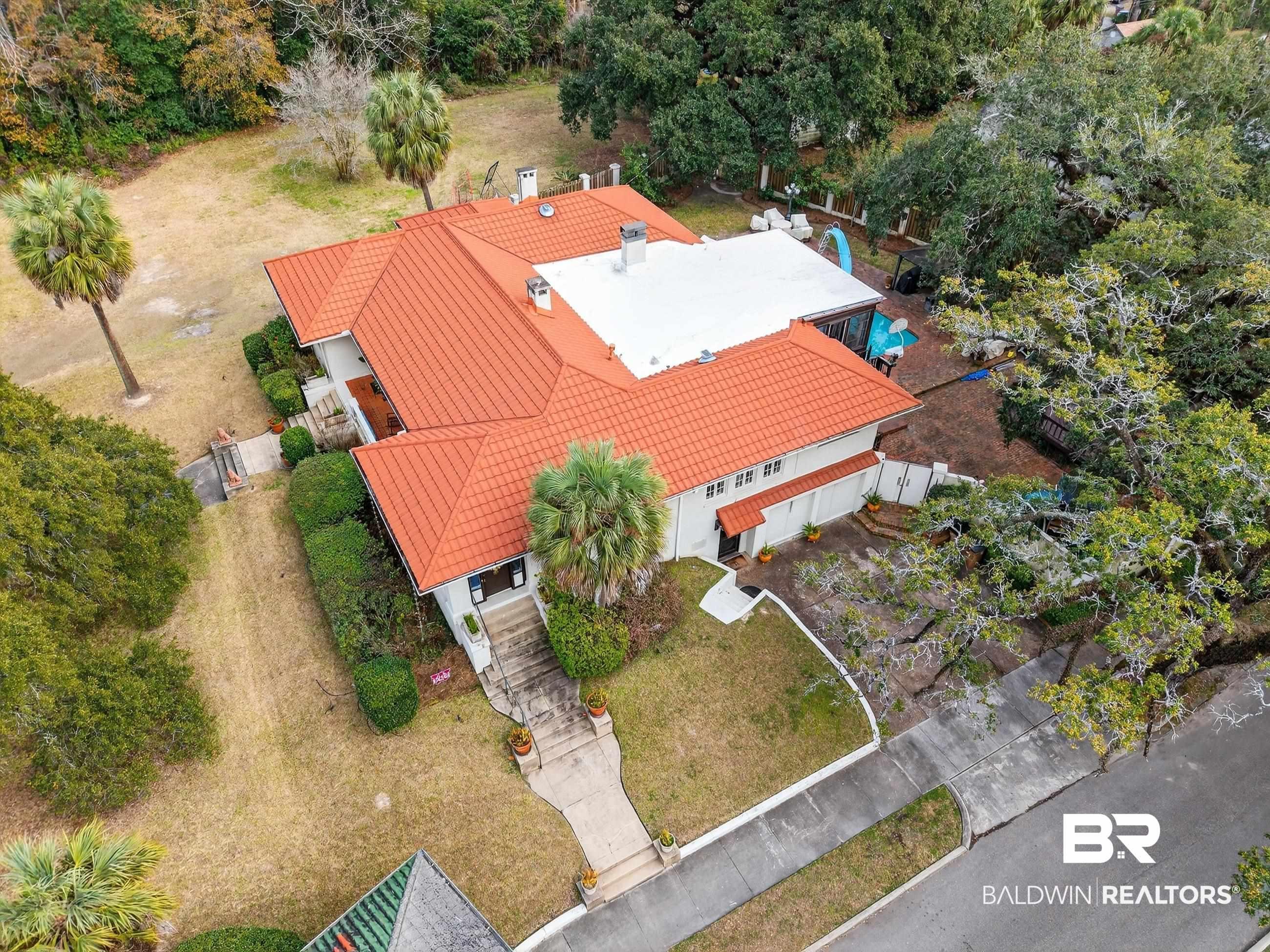 Image 3: Aerial view of property and surrounding area featuring a tree filled landscape