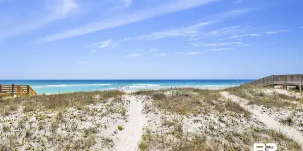 Image 4: Expansive sandy beach with a clear blue ocean backdrop