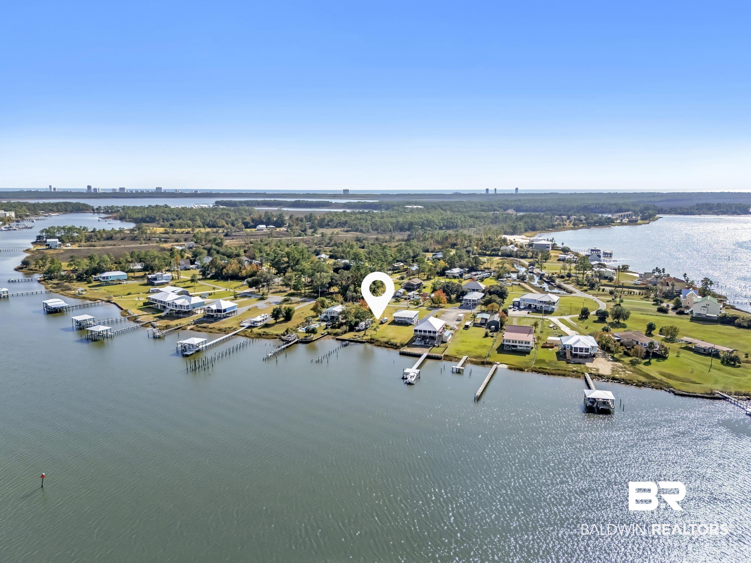 Image 4: Aerial perspective of suburban area featuring a nearby body of water