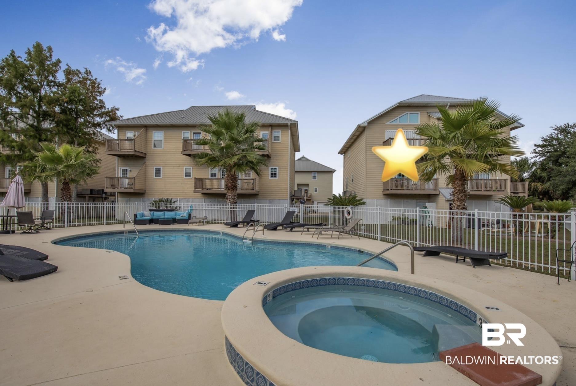 Image 2: Community pool with a patio and a hot tub