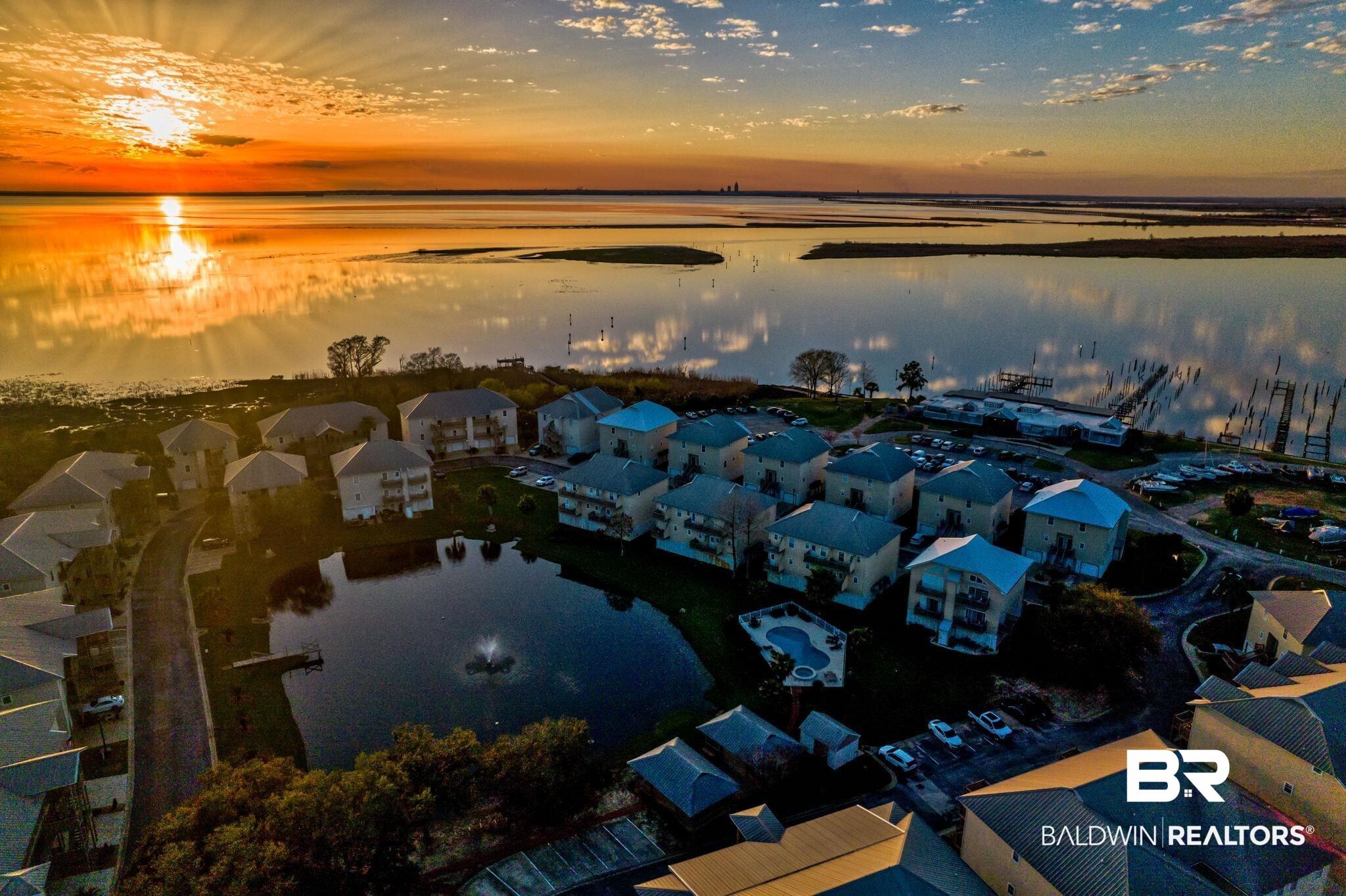 Image 4: Aerial view at dusk of a water view and a residential view