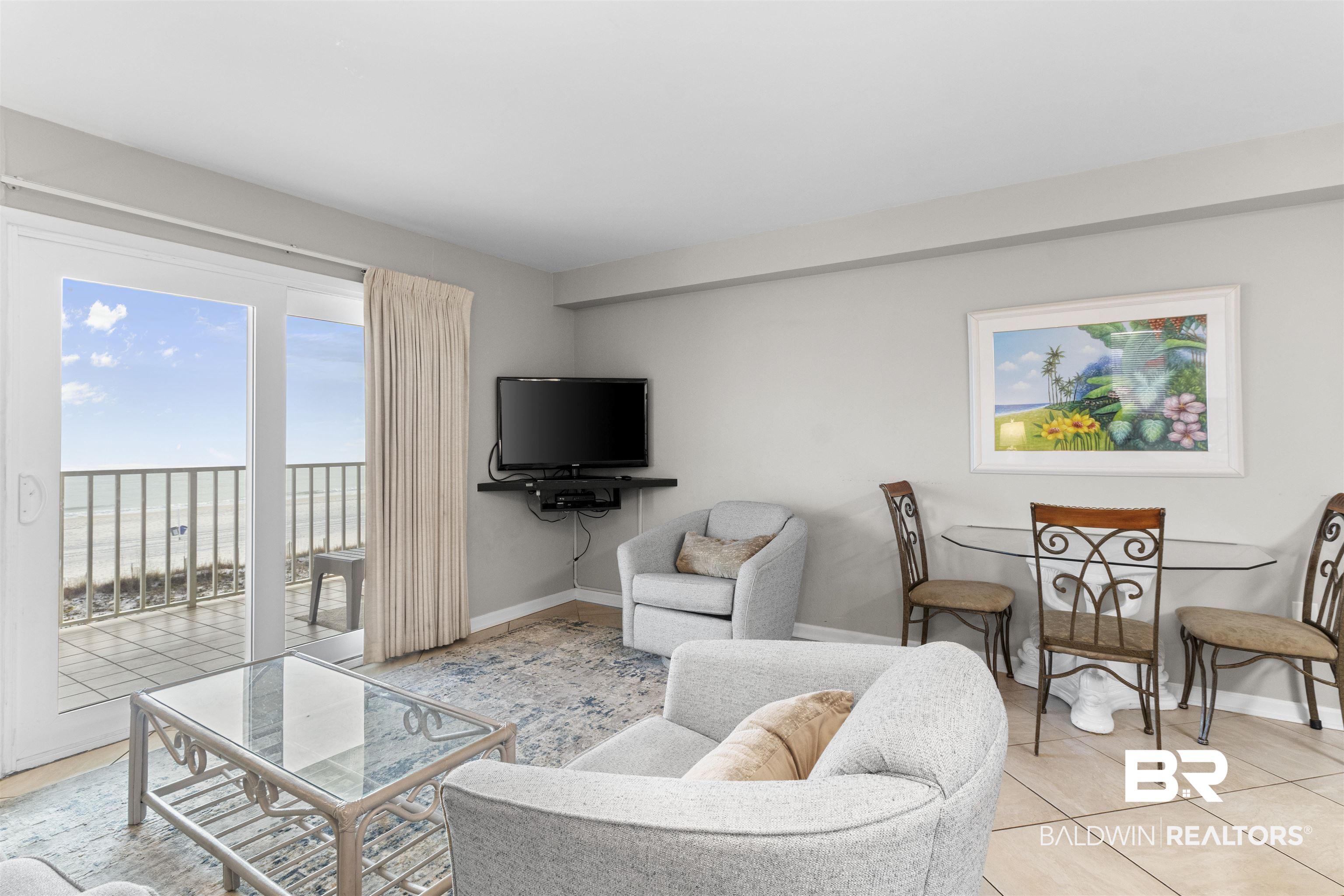 Image 2: Tiled living room featuring baseboards