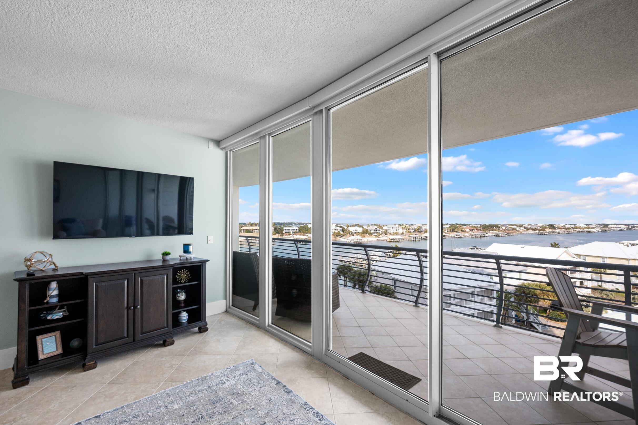 Image 4: Sunroom / solarium featuring a water view