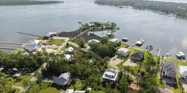 Image 2: Aerial perspective of suburban area featuring a large body of water