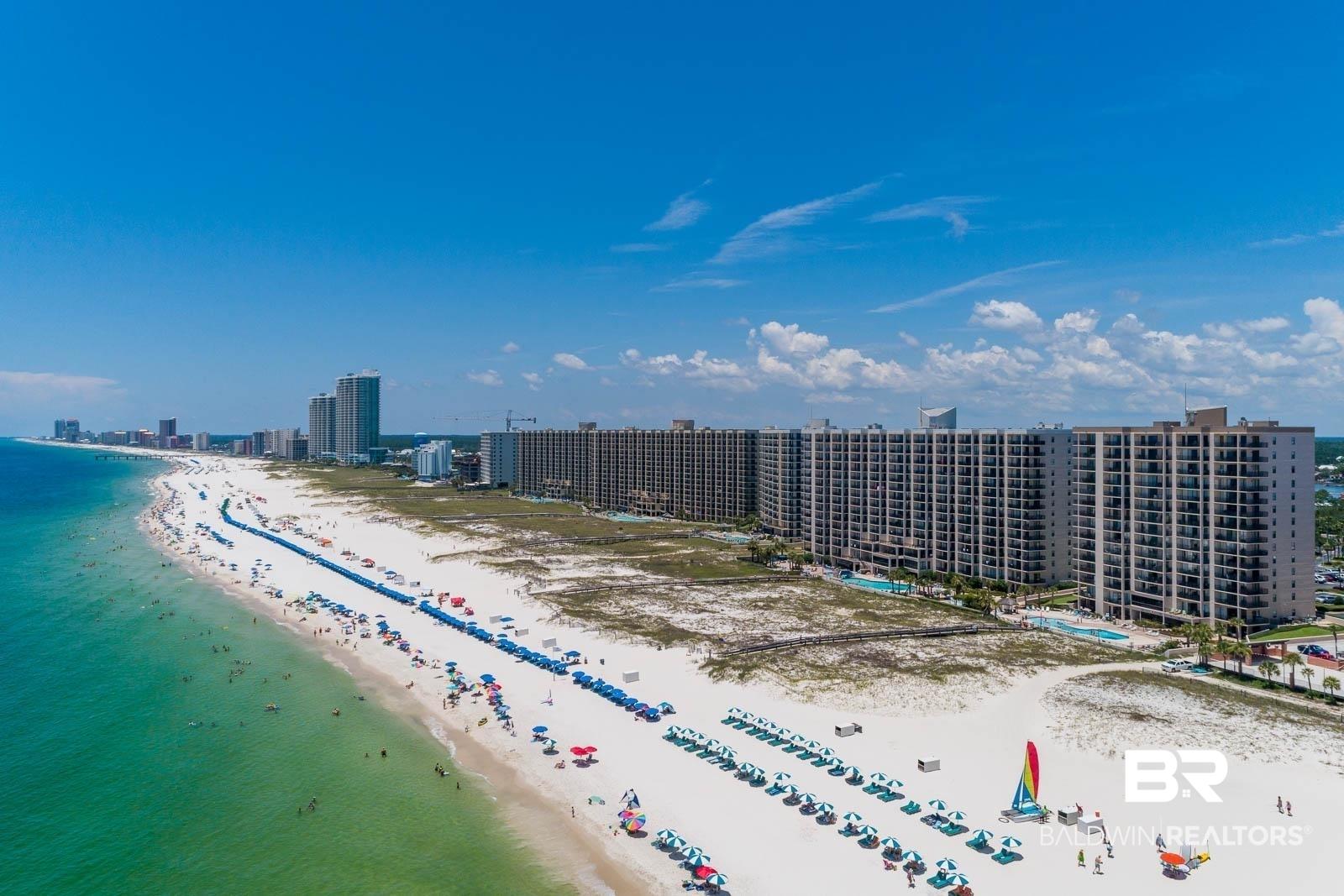 Image 2: Extensive beachfront development featuring multiple high-rise buildings with private balconies
