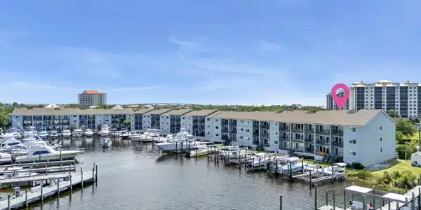 Image 2: Waterfront condominium complex featuring a multi-slip marina