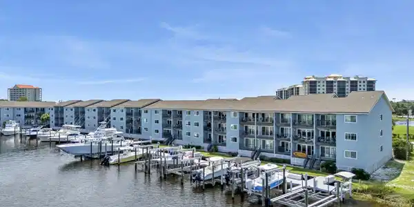 Image 4: Waterfront condominium complex featuring multiple boat slips and direct water access