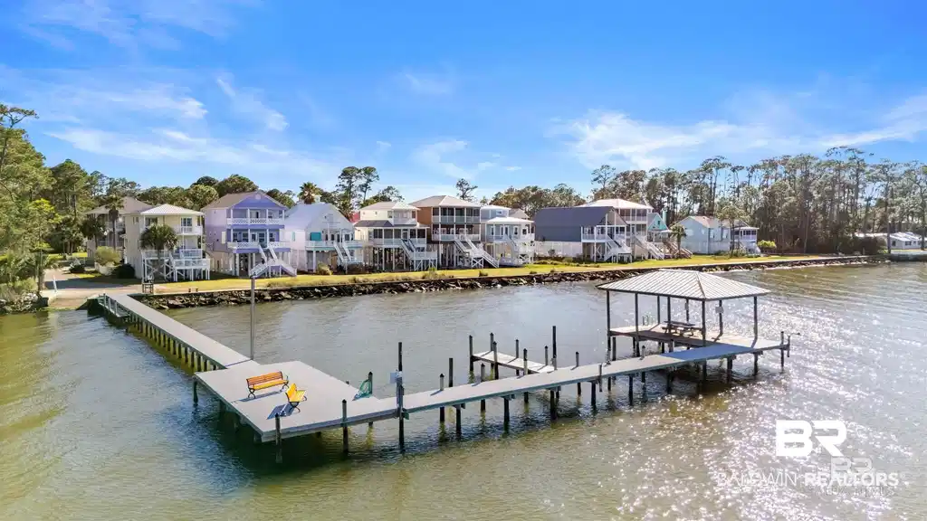 Image 1: Dock featuring a residential view, a water view, and boat lift