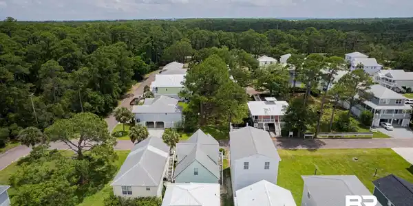 Image 2: Aerial view of residential area with a forest
