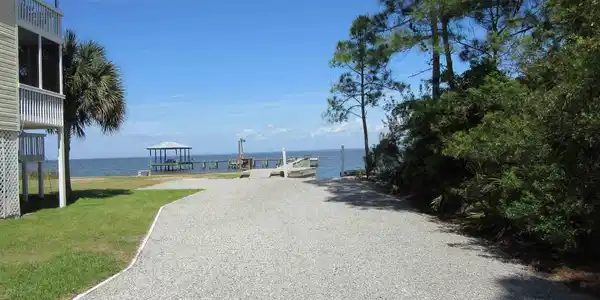 Image 4: View of dirt / gravel road featuring a boat ramp and a water view