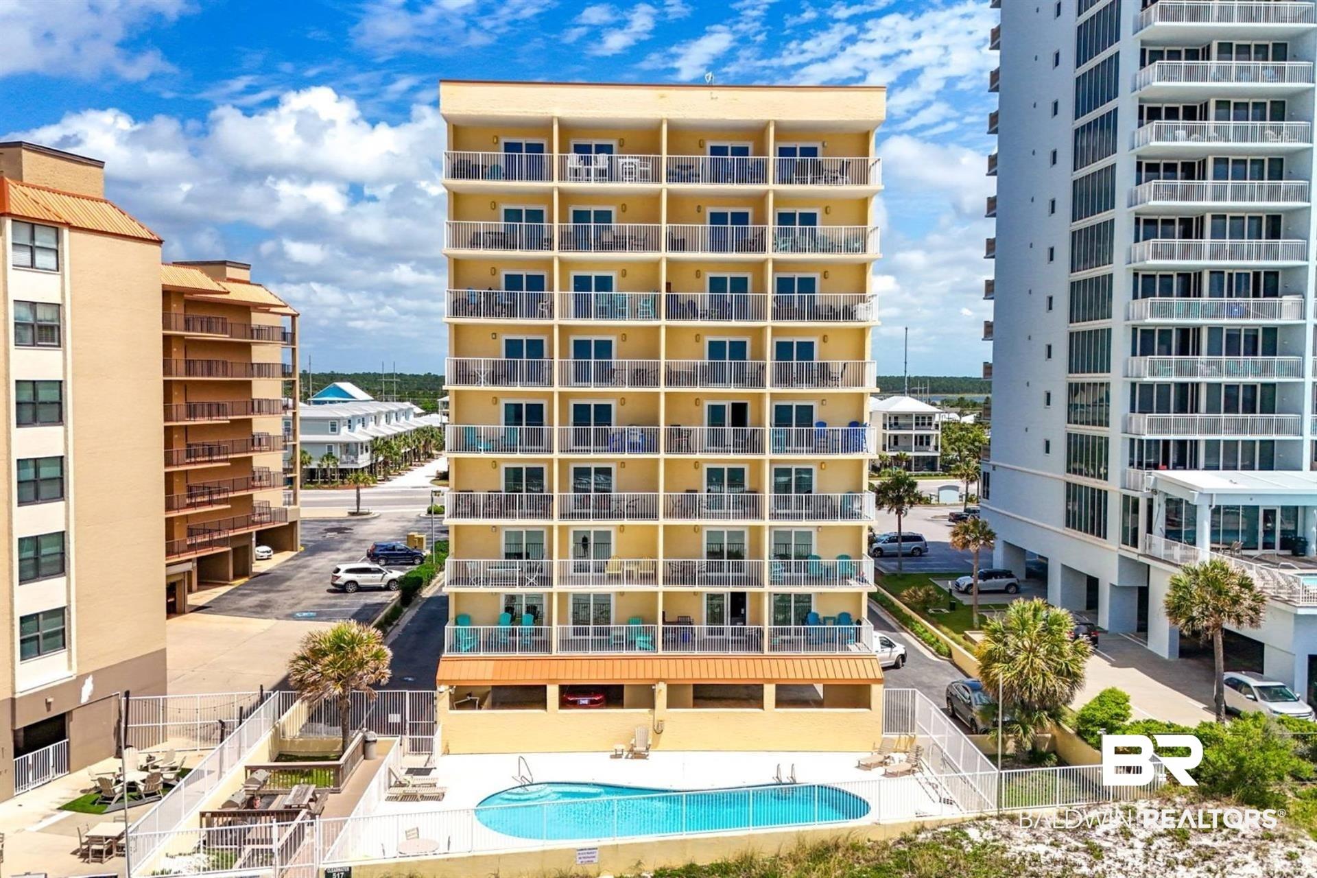 Image 3: View of apartment building / complex with a community pool