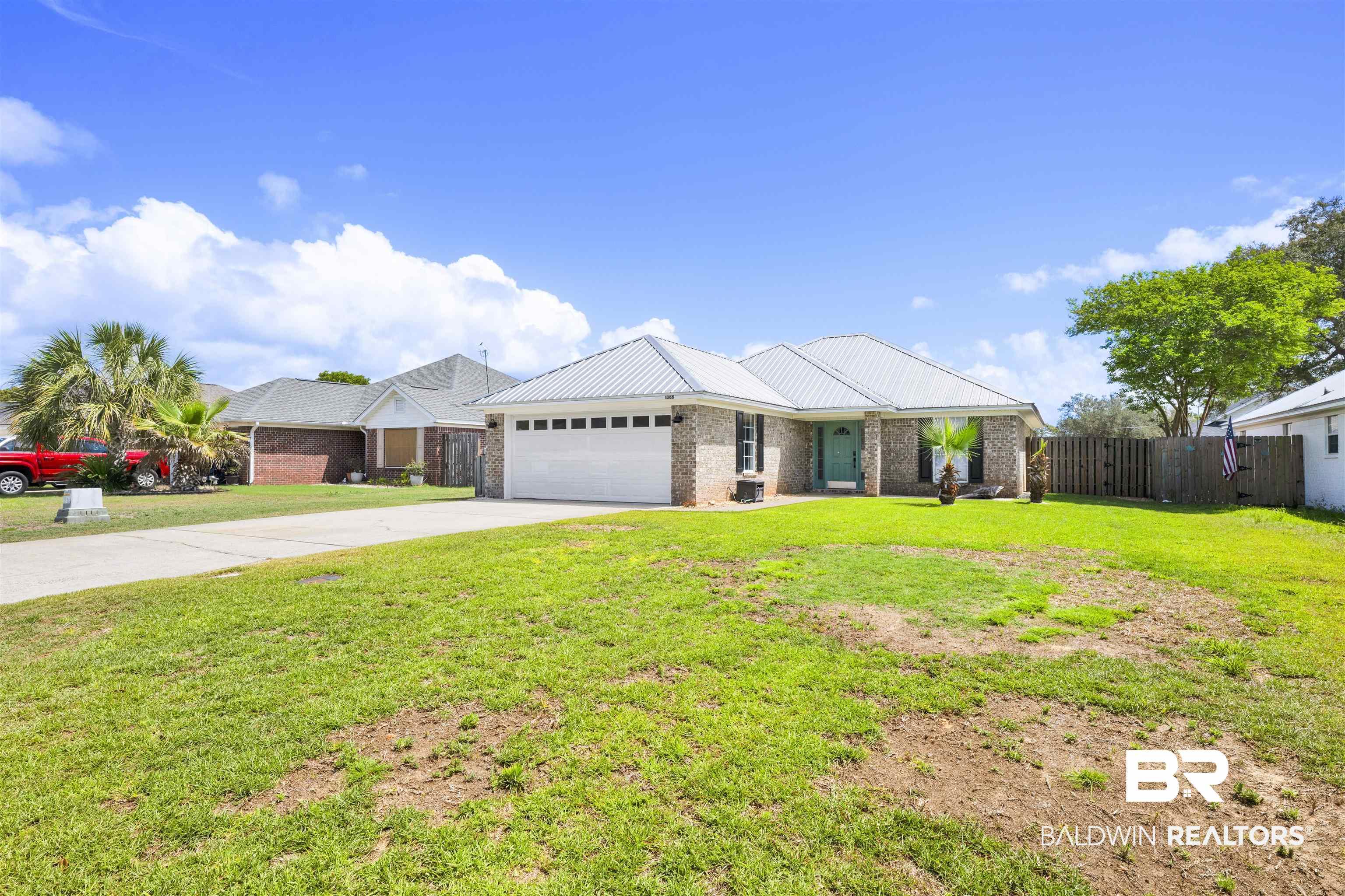 Image 2: Ranch-style house with driveway, an attached garage, and brick siding