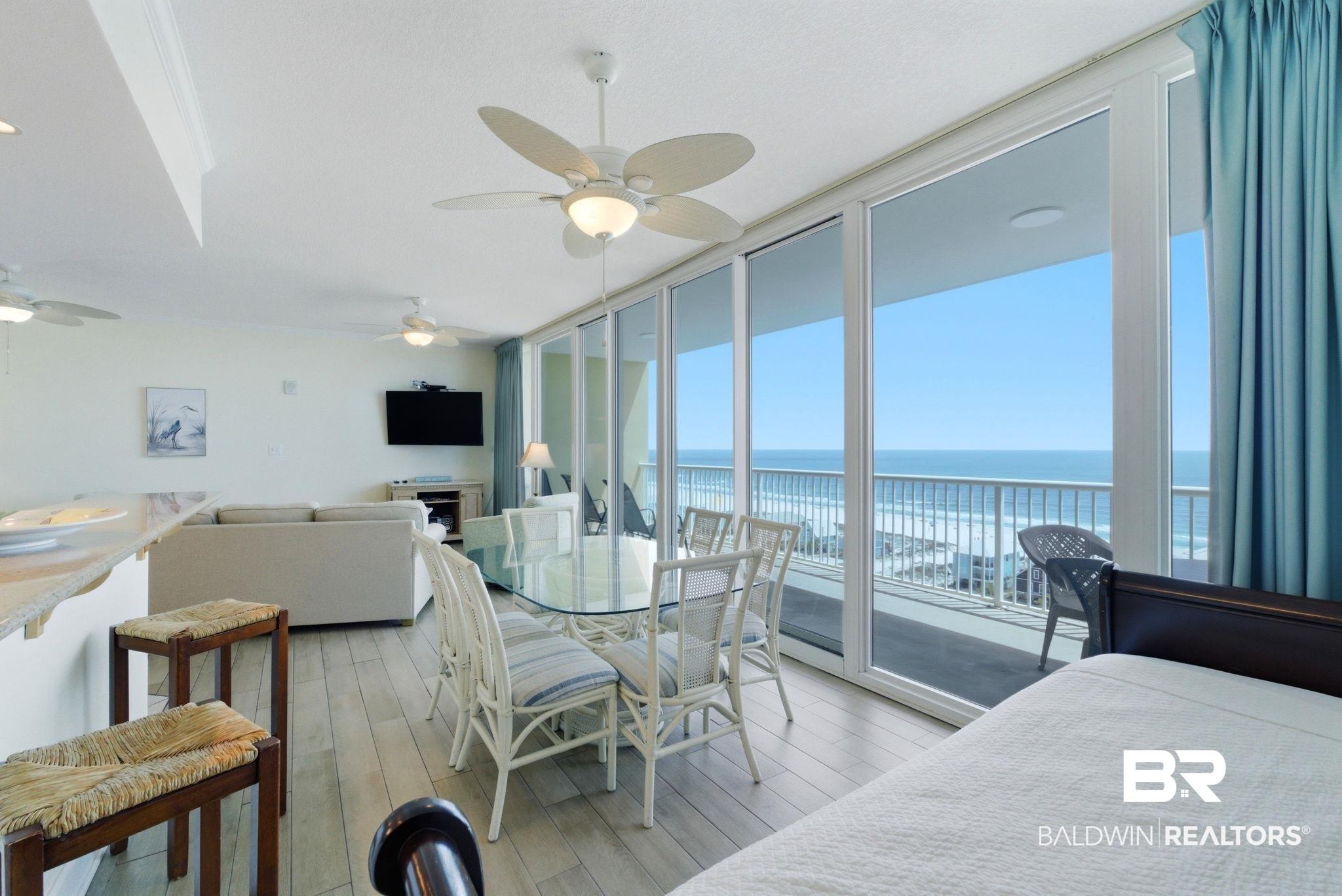 Image 3: Dining space featuring floor to ceiling windows, light wood-style flooring, and ceiling fan