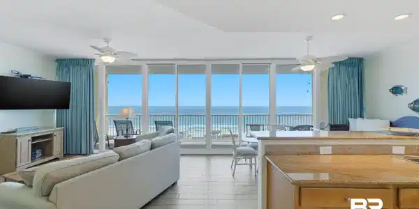 Image 4: Living area featuring ceiling fan, crown molding, floor to ceiling windows, a water view, and wood tiled floors
