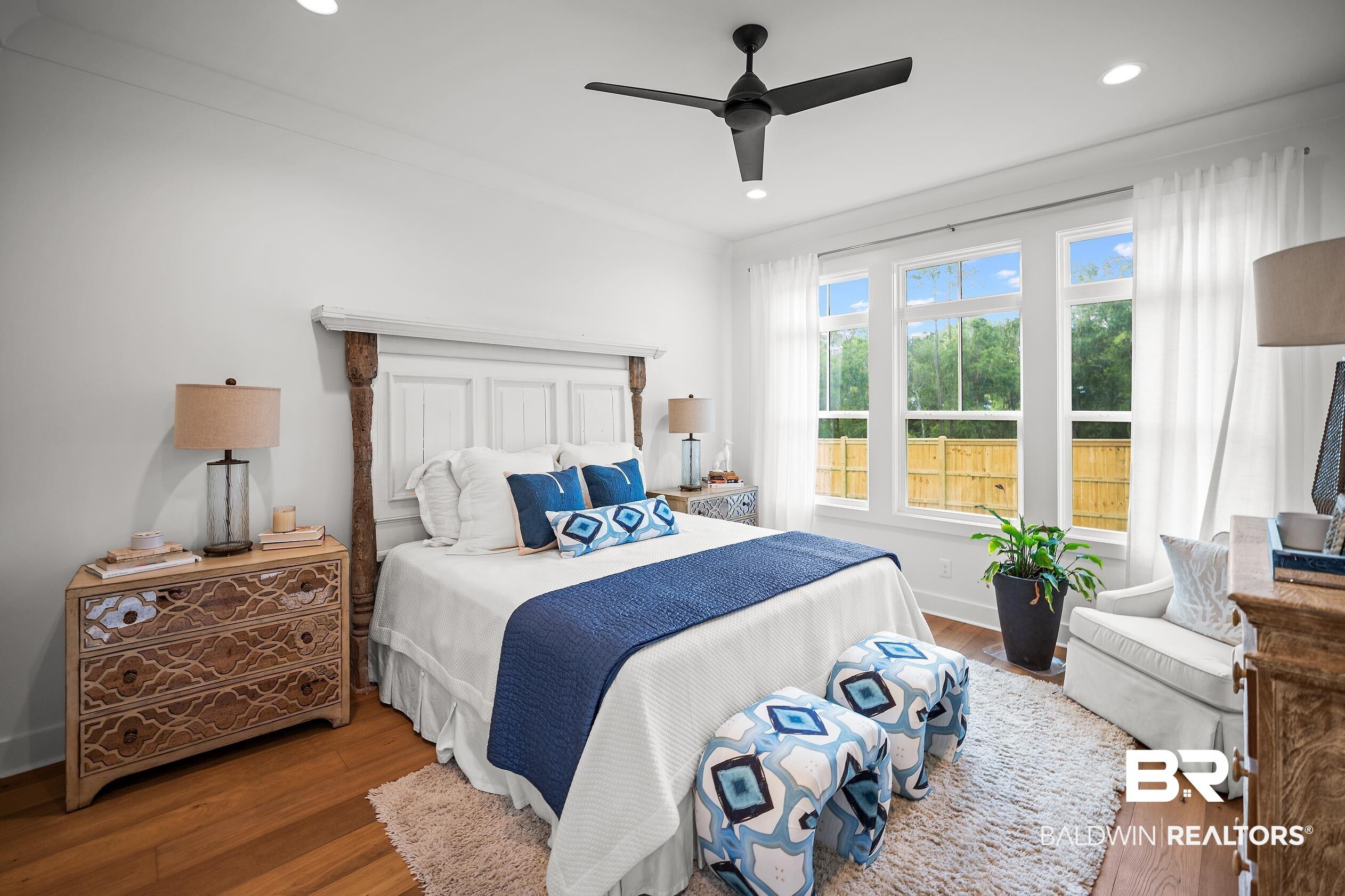 Image 3: Bedroom featuring wood-finish flooring, recessed lighting, and a black ceiling fan