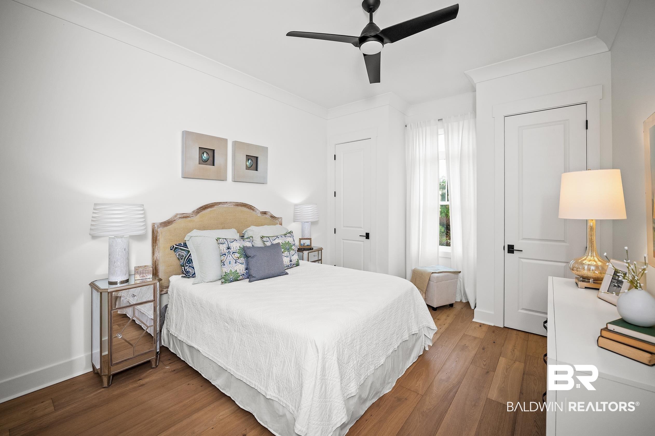 Image 4: Spacious room featuring wood-finish flooring, white walls, and crown molding