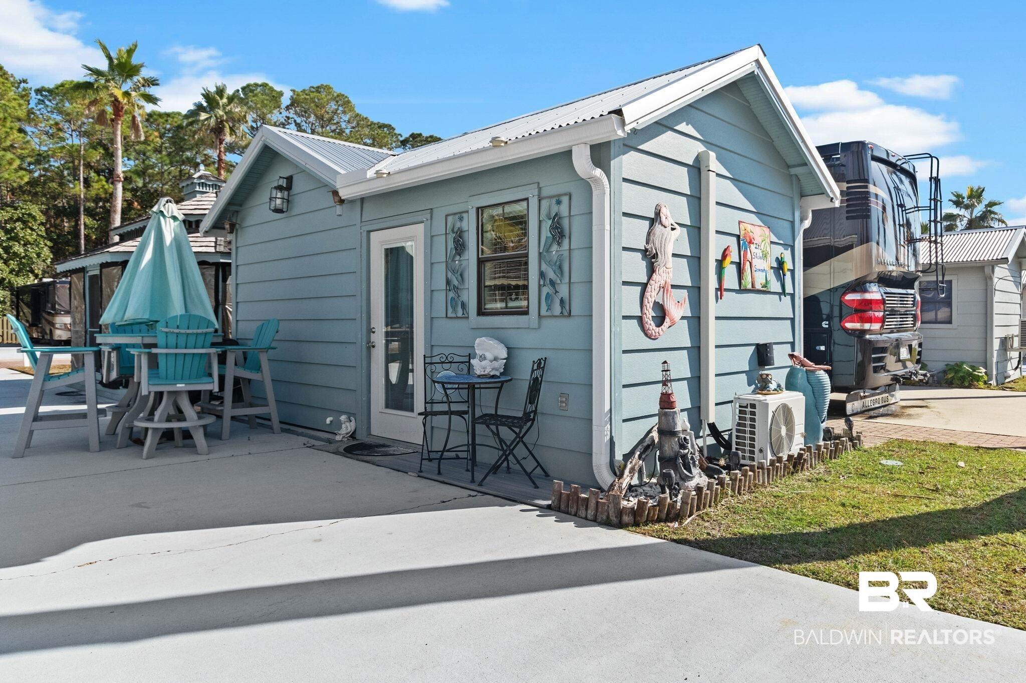 Image 2: View of front of property with a metal roof