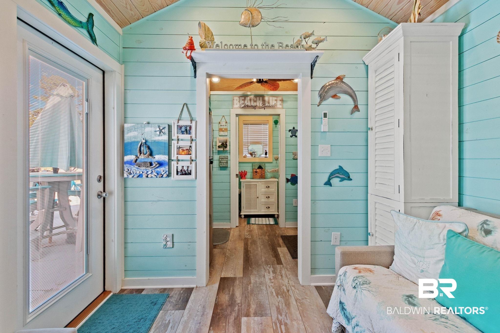 Image 4: Bathroom with wood walls, wood-type flooring, vaulted ceiling, and wood ceiling