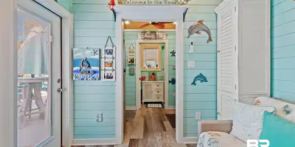 Image 4: Bathroom with wood walls, wood-type flooring, vaulted ceiling, and wood ceiling