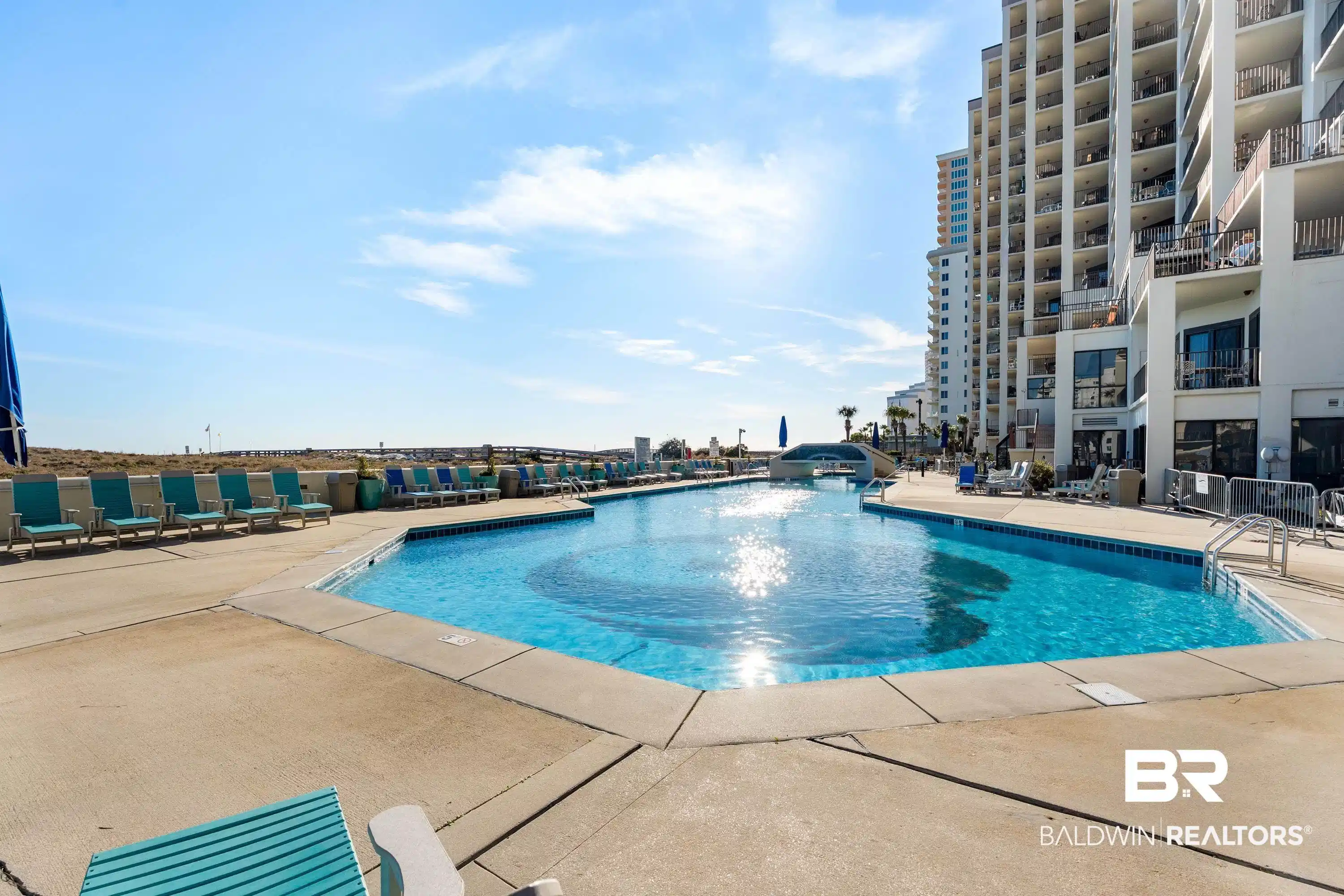 Image 1: Community pool featuring a patio area