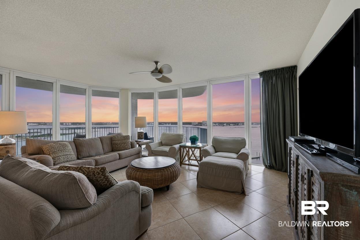 Image 4: Living area featuring panoramic water scenery through expansive windows