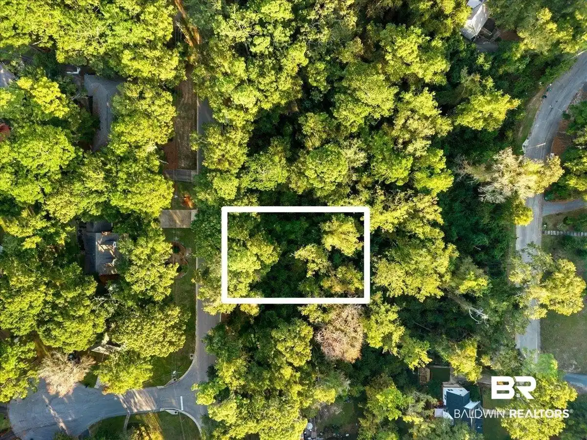 Image 1: Aerial view of property and surrounding area featuring property parcel outlined