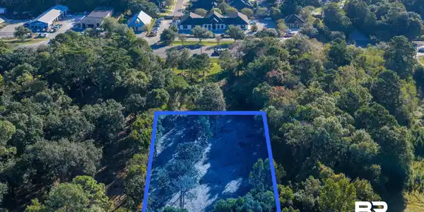 Image 2: Aerial view of property and surrounding area with property parcel outlined