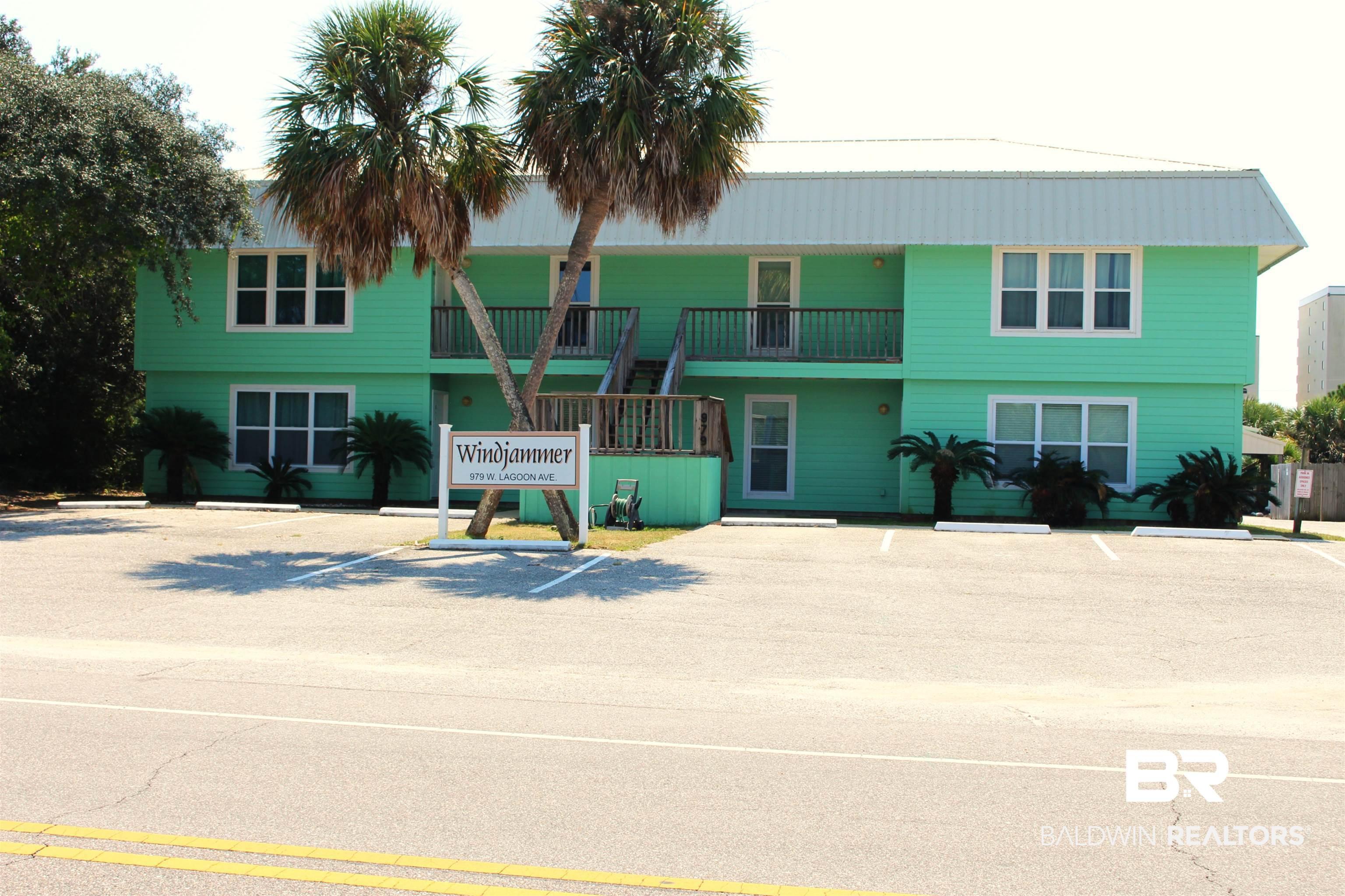 Image 1: View of building exterior with uncovered parking