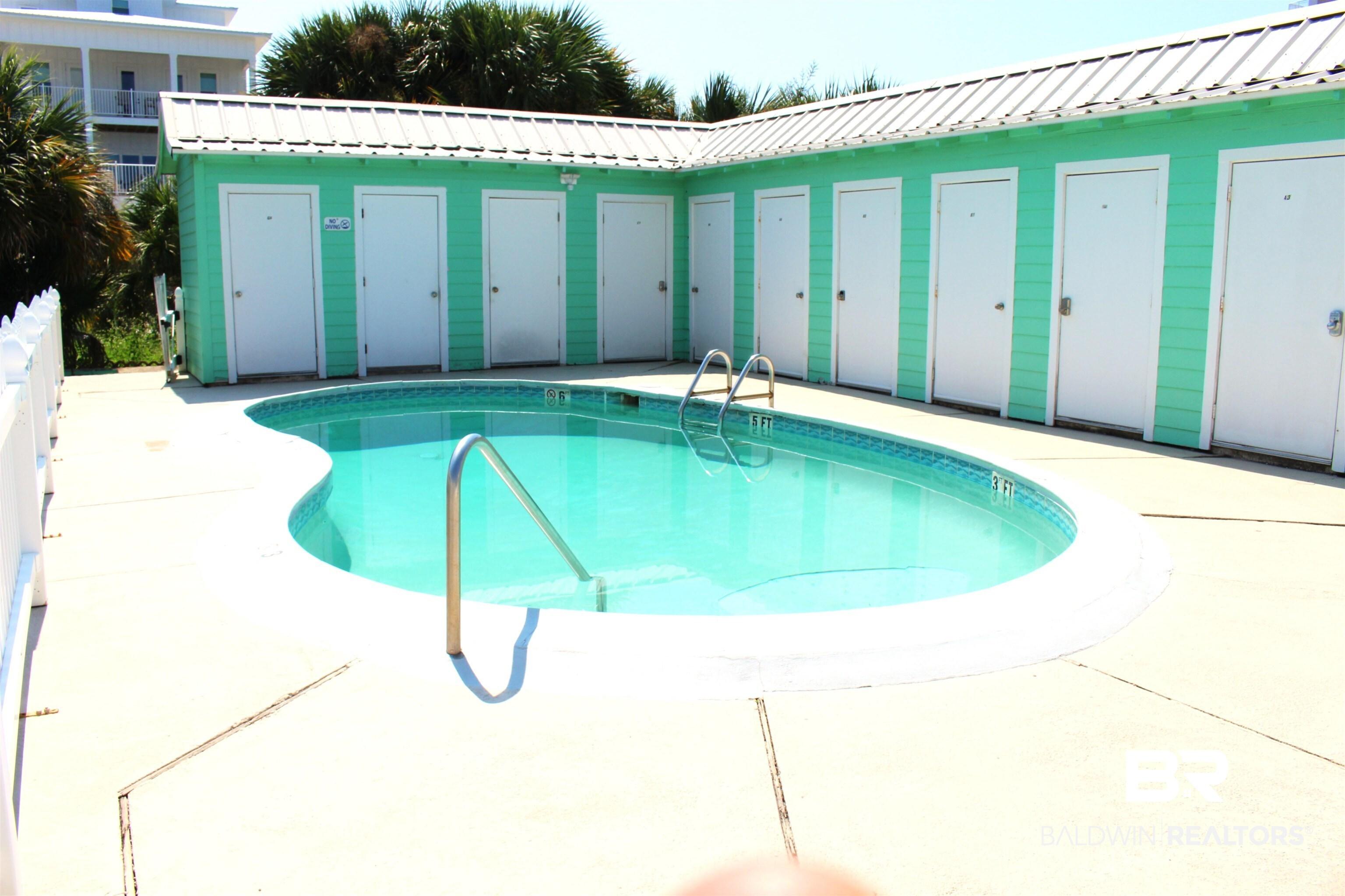 Image 3: Community pool with a patio area