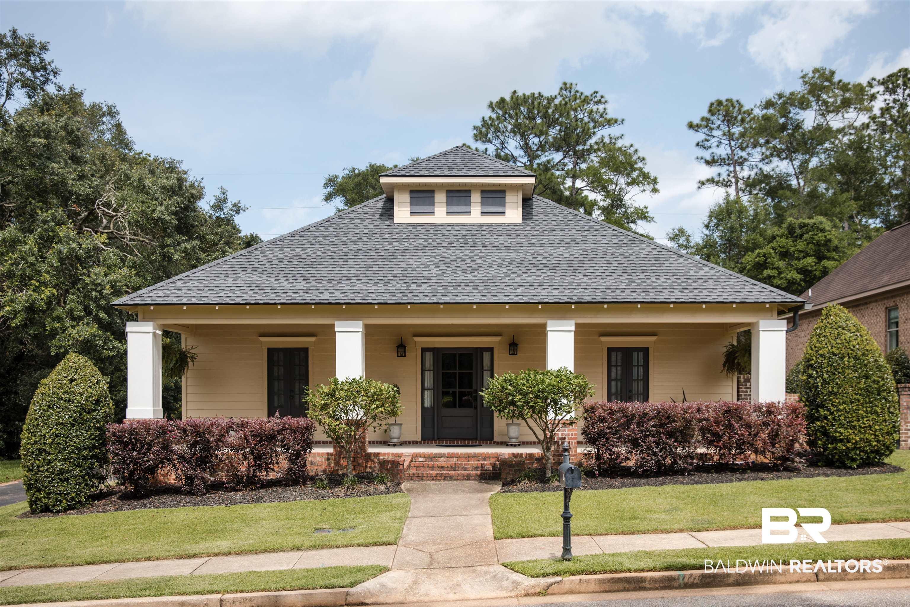 Image 1: Single-story residence featuring a covered front porch with white columns, a gray shingle roof, and a central cupola