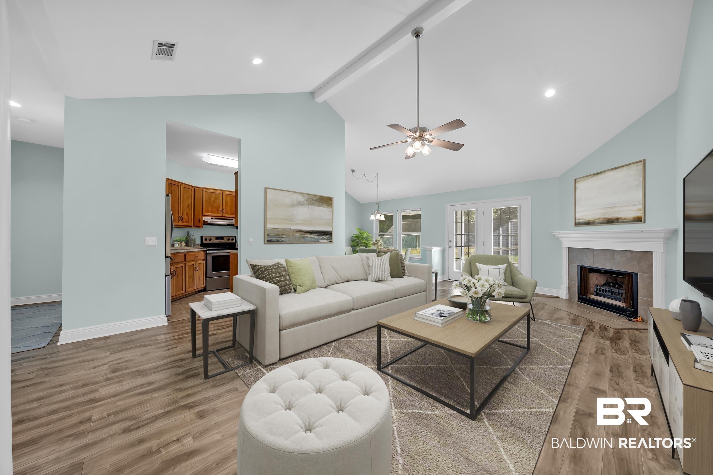 Image 2: Living room featuring a tile fireplace, recessed lighting, beamed ceiling, light wood-style floors, and a ceiling fan