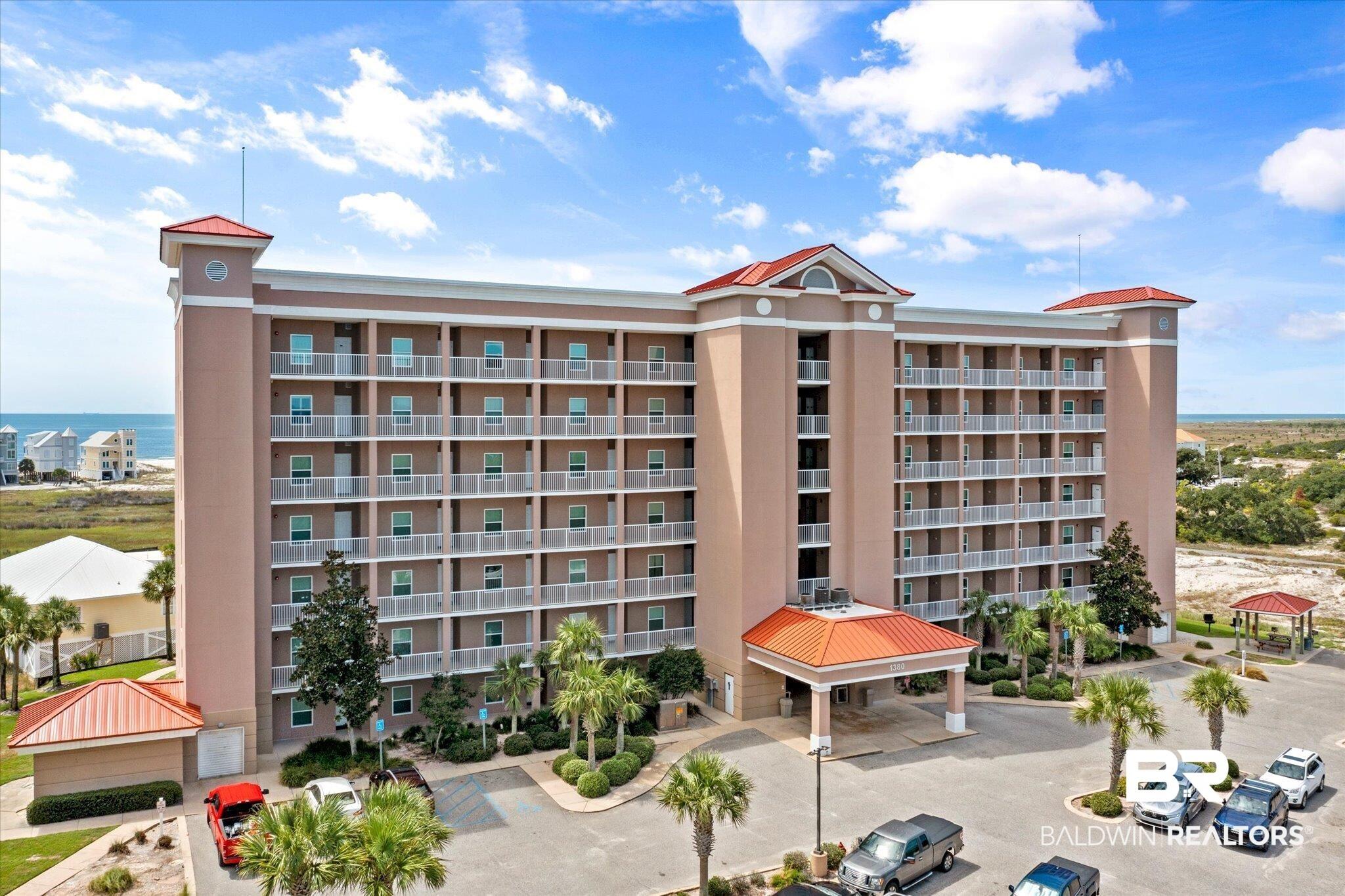 Image 2: View of apartment building / complex with uncovered parking